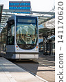 Modern electric tram arriving at a station platform in the Netherlands on a sunny spring day 141170620