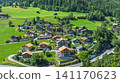 Aerial view of a picturesque Swiss village with wooden chalets in the green Alpine landscape 141170623