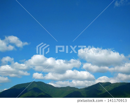 A refreshing natural landscape of summer mountains with a clear blue sky and white clouds. A refreshing natural landscape of summer mountains with a clear blue sky and white clouds. 141170913