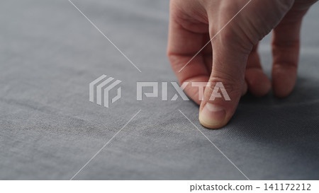 man manually check gray blue color cotton fabric for clothing with hands man manually check gray blue color cotton fabric for clothing with hands 141172212