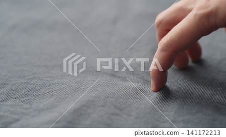 man manually check corduroy blue color cotton fabric for clothing with hands man manually check corduroy blue color cotton fabric for clothing with hands 141172213