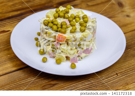 Traditional Russian festive salad Olivier on wooden table Traditional Russian festive salad Olivier on wooden table 141172318