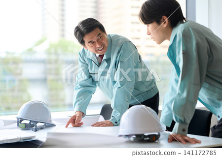 A man in work clothes having a meeting A man in work clothes having a meeting 141172785