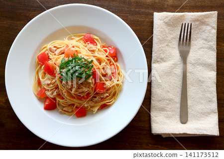 Tuna and tomato pasta viewed from directly above the table background. Tuna and tomato pasta viewed from directly above the table background. 141173512