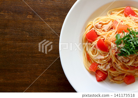 Tuna and tomato pasta viewed from directly above the table background. Tuna and tomato pasta viewed from directly above the table background. 141173518