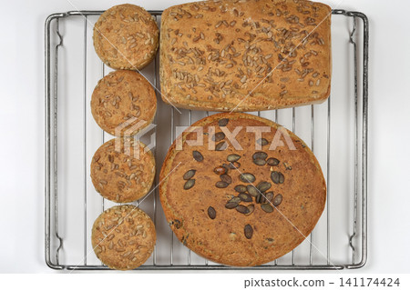 Homemade Seeded Bread and Buns on Cooling Rack Homemade Seeded Bread and Buns on Cooling Rack 141174424