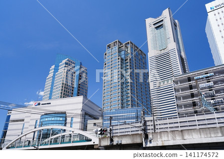 The cluster of office buildings around Yokohama's Sakuragicho Station and the Landmark Tower stand tall against the clear blue sky. The cluster of office buildings around Yokohama's Sakuragicho Station and the Landmark Tower stand tall against the clear blue sky. 141174572
