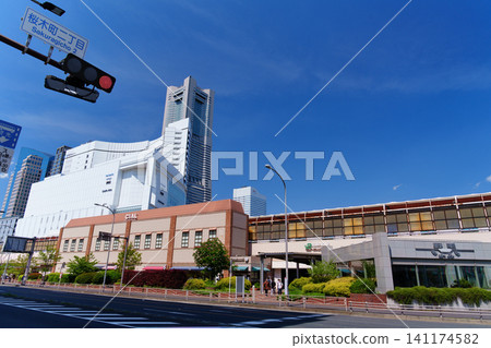 The cluster of office buildings around Yokohama's Sakuragicho Station and the Landmark Tower stand tall against the clear blue sky. 141174582