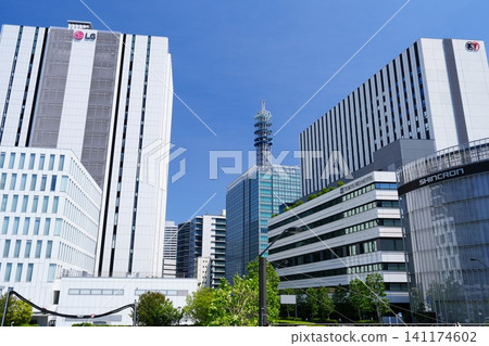 The modern office buildings of Yokohama's Minato Mirai Shin-Takashima area stand tall against a clear blue sky. The modern office buildings of Yokohama's Minato Mirai Shin-Takashima area stand tall against a clear blue sky. 141174602