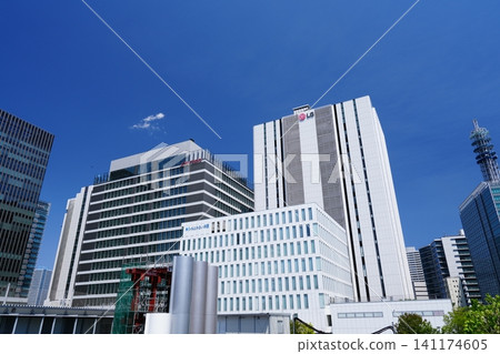 The modern office buildings of Yokohama's Minato Mirai Shin-Takashima area stand tall against a clear blue sky. The modern office buildings of Yokohama's Minato Mirai Shin-Takashima area stand tall against a clear blue sky. 141174605