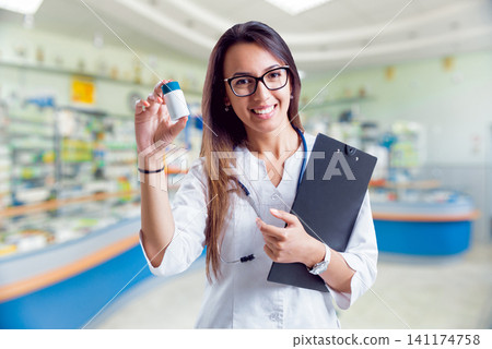 Pharmacist showing medication 141174758