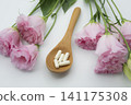 Pink flowers and beauty supplements 141175308