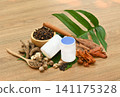 Traditional Thai herbal ingredients used in an ancient Thai inhaler recipe, featuring aromatic medicinal plants and natural remedies on a rustic wooden background. 141175328