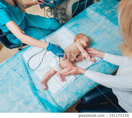 Doctor and little boy patient. Ultrasound equipment. Sonography. Hip dysplasia Doctor and little boy patient. Ultrasound equipment. Sonography. Hip dysplasia 141175330