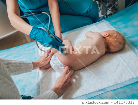 Doctor and little boy patient. Ultrasound equipment. Sonography. Hip dysplasia Doctor and little boy patient. Ultrasound equipment. Sonography. Hip dysplasia 141175332