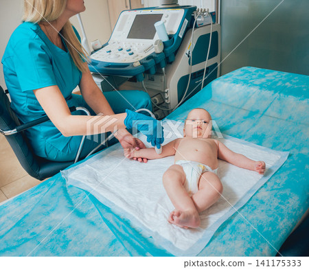 Doctor and little boy patient. Ultrasound equipment. Diagnostics. Sonography. Doctor and little boy patient. Ultrasound equipment. Diagnostics. Sonography. 141175333