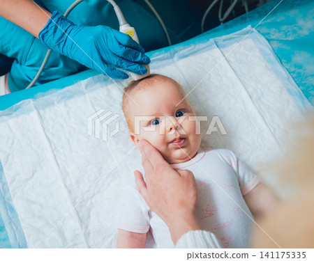 Doctor and little boy patient. Ultrasound equipment. Diagnostics. Sonography. Doctor and little boy patient. Ultrasound equipment. Diagnostics. Sonography. 141175335