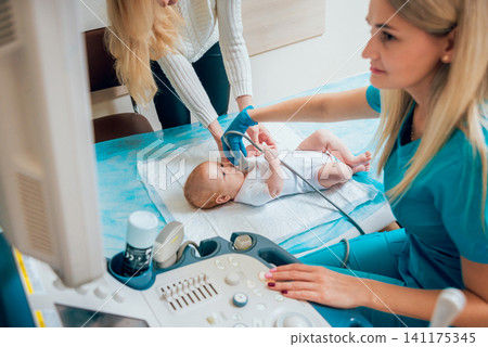 Doctor and little boy patient. Ultrasound equipment. Diagnostics. Sonography. Doctor and little boy patient. Ultrasound equipment. Diagnostics. Sonography. 141175345