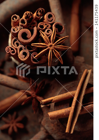 Cinnamon sticks and anise on a rusty background. Cinnamon sticks and anise on a rusty background. 141175439