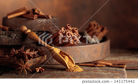 Cinnamon and anise on a brown vintage background. Cinnamon and anise on a brown vintage background. 141175442