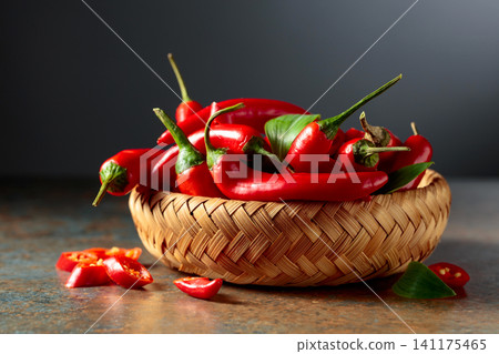 Red hot chili peppers in wicker dish. Red hot chili peppers in wicker dish. 141175465