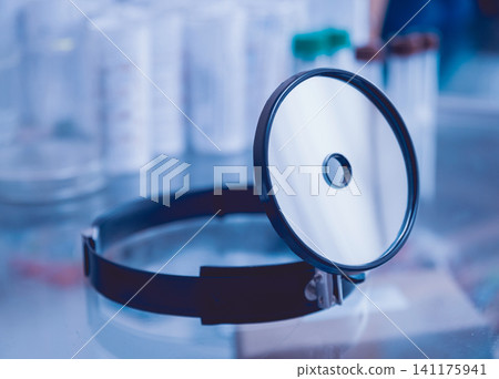 Medical frontal reflector on the table. 141175941