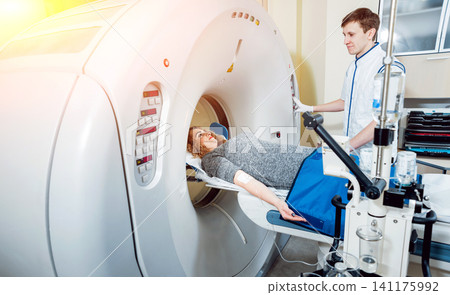 Medical equipment. Doctor and patient in the room of computed tomography Medical equipment. Doctor and patient in the room of computed tomography 141175992
