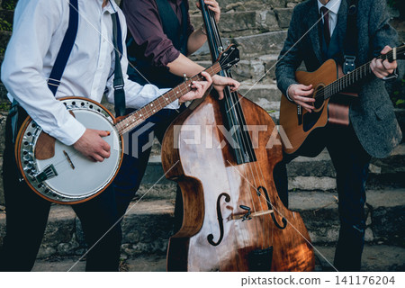 Trio of musicians with a guitar, banjo and contrabass Trio of musicians with a guitar, banjo and contrabass 141176204
