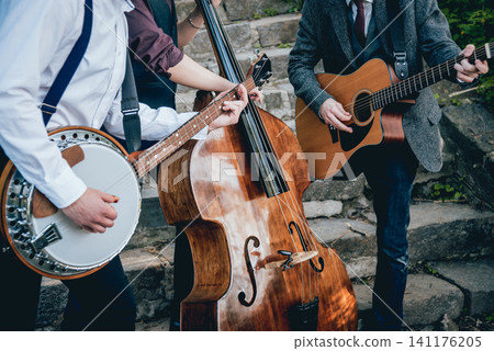Trio of musicians with a guitar, banjo and contrabass 141176205