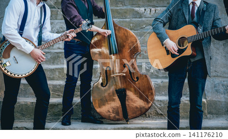 Trio of musicians with a guitar, banjo and contrabass 141176210