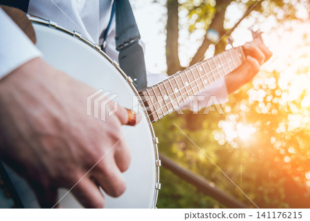 View of musician playing banjo at the street View of musician playing banjo at the street 141176215