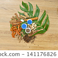 Traditional Thai herbal ingredients used in an ancient Thai inhaler recipe, featuring aromatic medicinal plants and natural remedies on a rustic wooden background. 141176826
