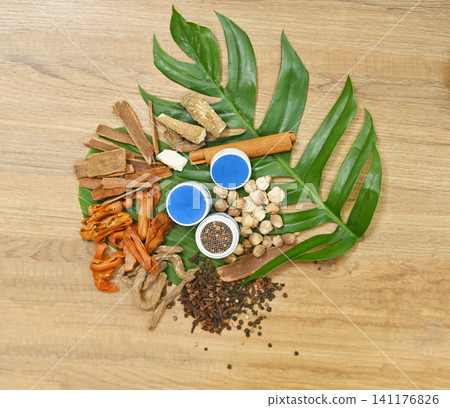 Traditional Thai herbal ingredients used in an ancient Thai inhaler recipe, featuring aromatic medicinal plants and natural remedies on a rustic wooden background. Traditional Thai herbal ingredients used in an ancient Thai inhaler recipe, featuring aromatic medicinal plants and natural remedies on a rustic wooden background. 141176826