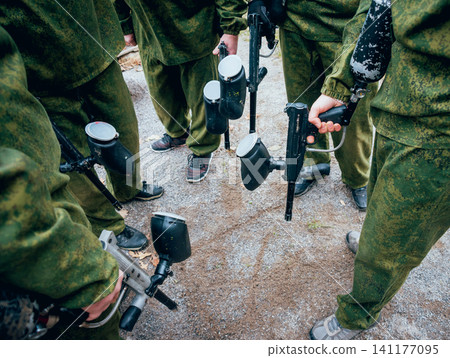 Men with guns playing at paintball. Outdoors Men with guns playing at paintball. Outdoors 141177095