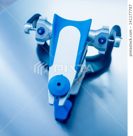 Dental technician working with articulator in dental lab Dental technician working with articulator in dental lab 141177787