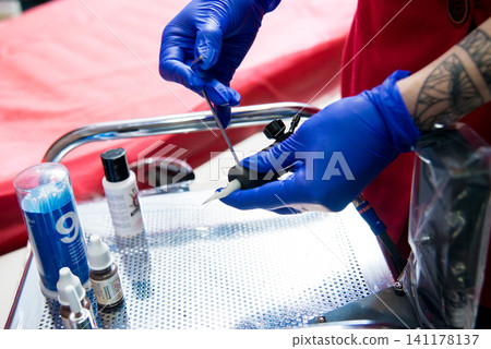 Professional tattooist makes the eyebrow tattoo Professional tattooist makes the eyebrow tattoo 141178137