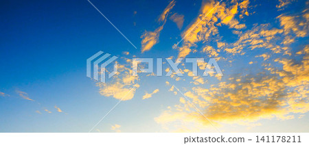 A simple landscape where the western sky glows dramatically as the sun is about to set. A simple landscape where the western sky glows dramatically as the sun is about to set. 141178211