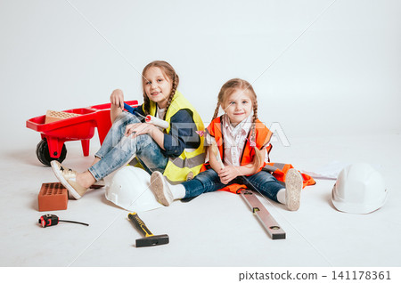 Little girls on the white background. Construction 141178361