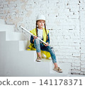 Little girl on the white background. Construction 141178371