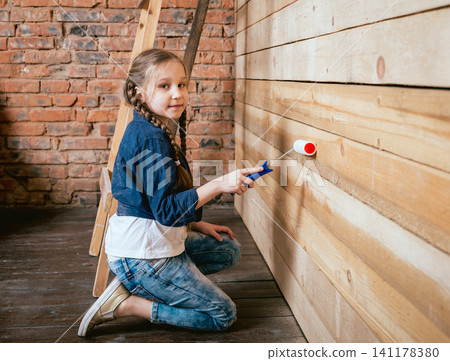 Little girl in a room with a wooden wall. Construction 141178380