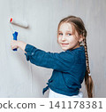 Little girl in a room with a wooden wall. Construction 141178381