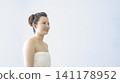 A beauty image of a young woman smiling in a bath towel. A beauty image of a young woman smiling in a bath towel. 141178952