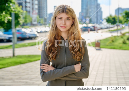 Portrait of beautiful confident young blonde woman looking at camera on modern city street Portrait of beautiful confident young blonde woman looking at camera on modern city street 141180393