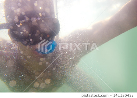 Man, snorkelling and underwater adventure for holiday vacation on tropical island for swimming, outdoor or explore. Male person, goggles and ocean travel in Florida for beach trip, journey or seaside Man, snorkelling and underwater adventure for holiday vacation on tropical island for swimming, outdoor or explore. Male person, goggles and ocean travel in Florida for beach trip, journey or seaside 141180452