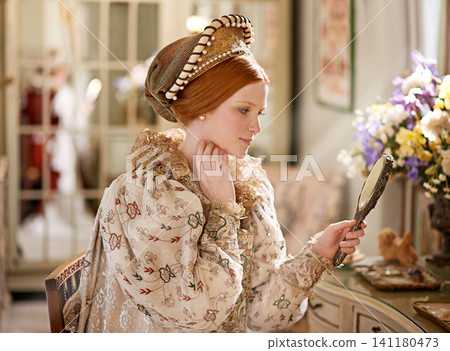Reflection, mirror and happy woman with renaissance, medieval and classic style in palace bedroom. Luxury, mansion and beauty skincare routine in home with vintage fashion and care of queen and ruler Reflection, mirror and happy woman with renaissance, medieval and classic style in palace bedroom. Luxury, mansion and beauty skincare routine in home with vintage fashion and care of queen and ruler 141180473