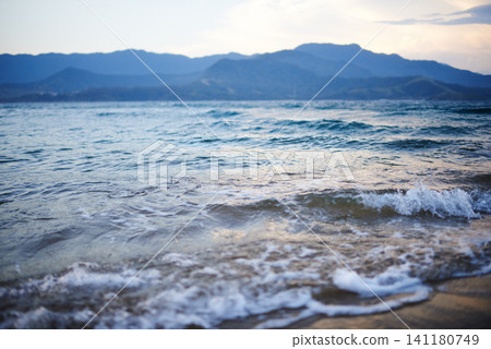 Travel, beach and water by ocean for vacation, holiday or adventure for paradise landscape. Blue sky, nature and sand by waves or sea on tropical island for outdoor weekend trip in summer on coast. 141180749