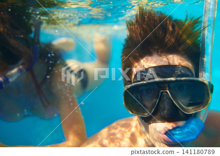 Scuba diving, underwater or face of couple swimming to explore for marine adventure, vacation or activity. Mask, divers or people at sea or ocean for travel, tropical environment or outdoor holiday Scuba diving, underwater or face of couple swimming to explore for marine adventure, vacation or activity. Mask, divers or people at sea or ocean for travel, tropical environment or outdoor holiday 141180789