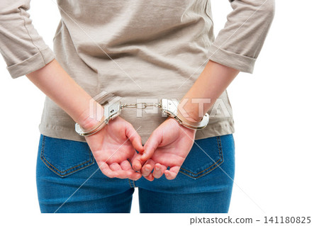 Criminal, handcuffs and arrest woman in studio with back view of prisoner for justice of law and crime. Person or thief, custody and restrained for jail for illegal counterfeiting in Venezuela Criminal, handcuffs and arrest woman in studio with back view of prisoner for justice of law and crime. Person or thief, custody and restrained for jail for illegal counterfeiting in Venezuela 141180825