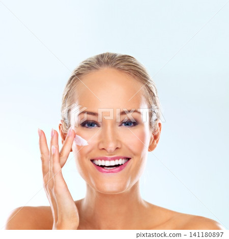 Woman, cream and portrait for skincare, dermatology and makeup for wellness, antiage and clean in studio. Model person and beautiful with smile for moisture and lipstick for hygiene on face Woman, cream and portrait for skincare, dermatology and makeup for wellness, antiage and clean in studio. Model person and beautiful with smile for moisture and lipstick for hygiene on face 141180897