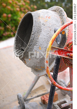 Construction site, machine or cement mixer for building, outdoor development project or labor process. Background, concrete or industrial equipment for mixing material, renovation business or service Construction site, machine or cement mixer for building, outdoor development project or labor process. Background, concrete or industrial equipment for mixing material, renovation business or service 141180967